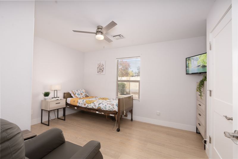 Bedroom with an adjustable bed and a wall-mounted television