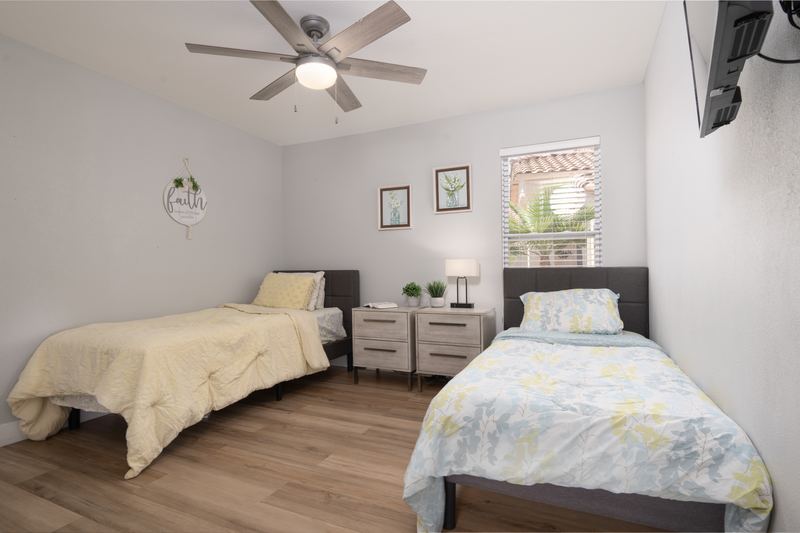 Shared bedroom with two beds and matching bedside lamps