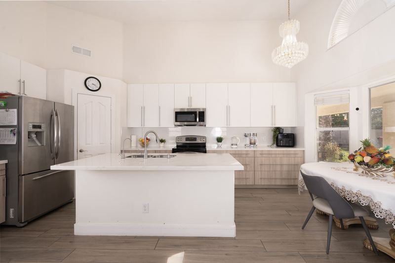 Kitchen with a large island, stainless appliances and a dining table