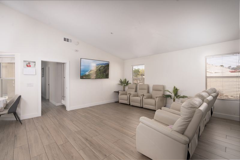 Family room with a row of recliners facing a wall-mounted television